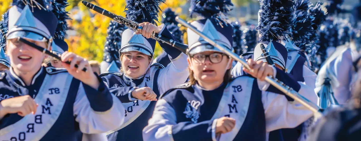 Marching band outdoors during homecoming.